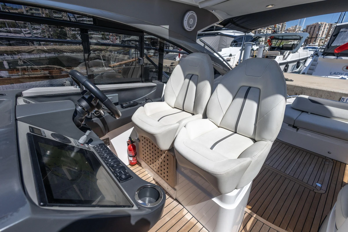 2019 Princess V40 yacht cockpit with dual white seats and modern control panel.