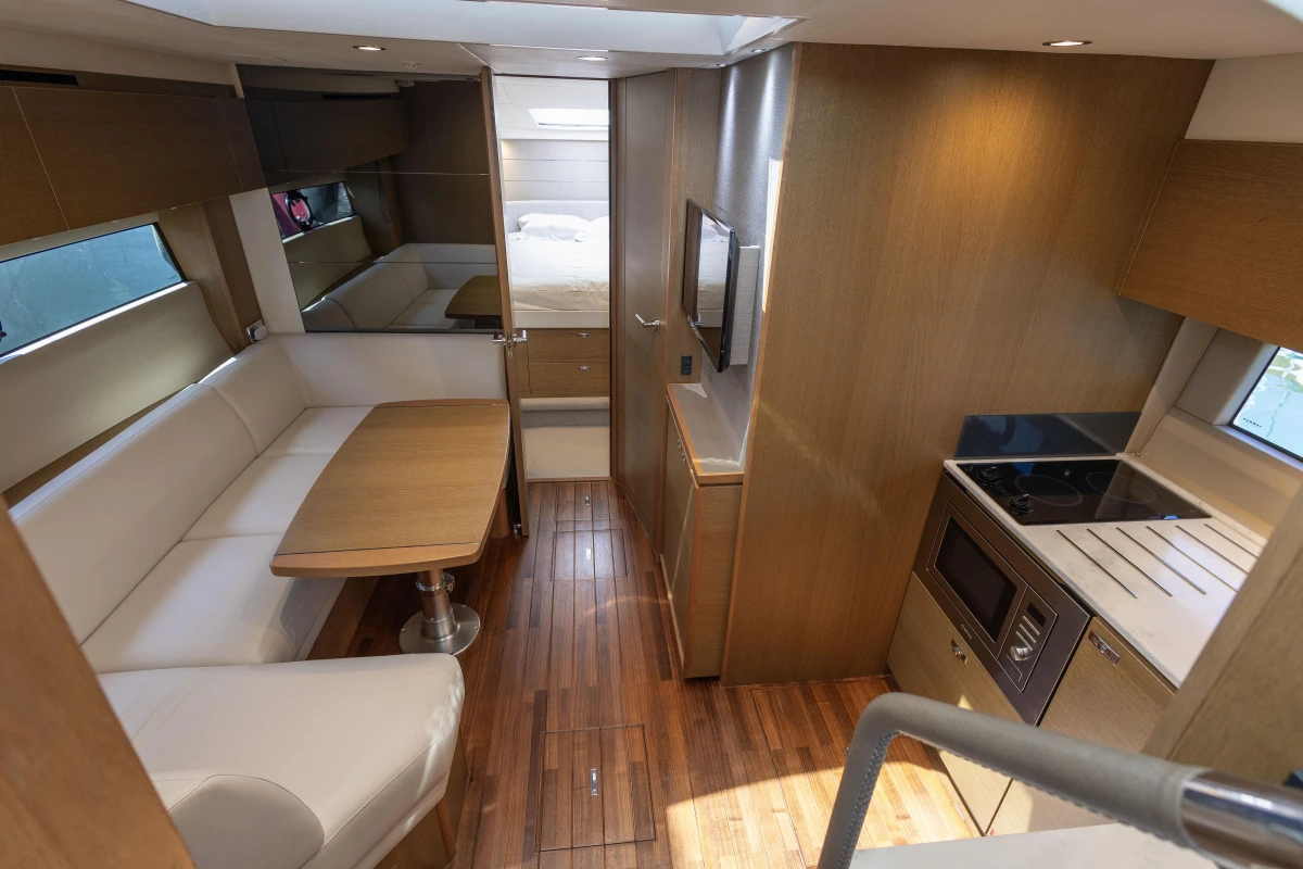 Luxurious interior of 2019 Princess V40 yacht with modern kitchen and dining area.