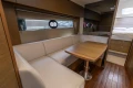 Luxurious interior of 2019 Princess V40 yacht with elegant seating and wooden table.