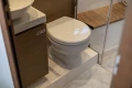 Modern bathroom in 2019 Princess V40 yacht with toilet and wooden accents.