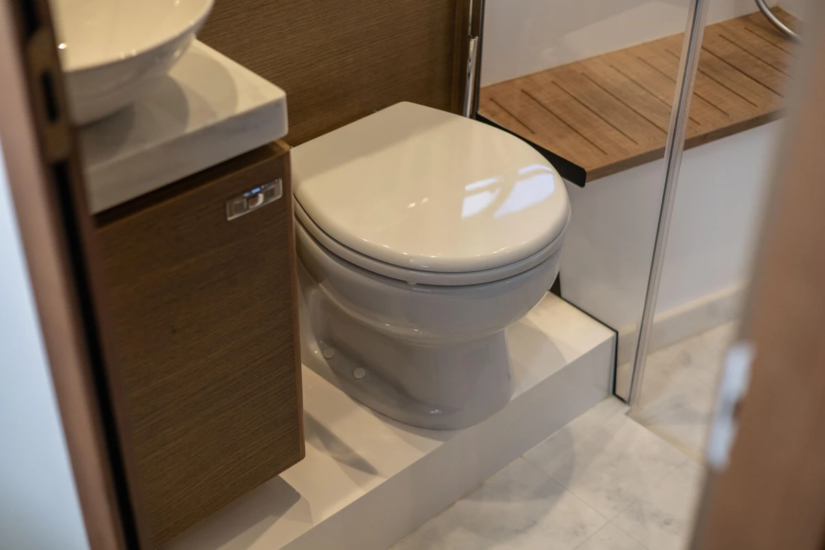 Modern bathroom in 2019 Princess V40 yacht with toilet and wooden accents.