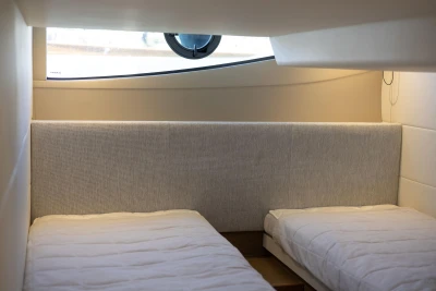Interior cabin of 2019 Princess V40 yacht with twin beds and window.