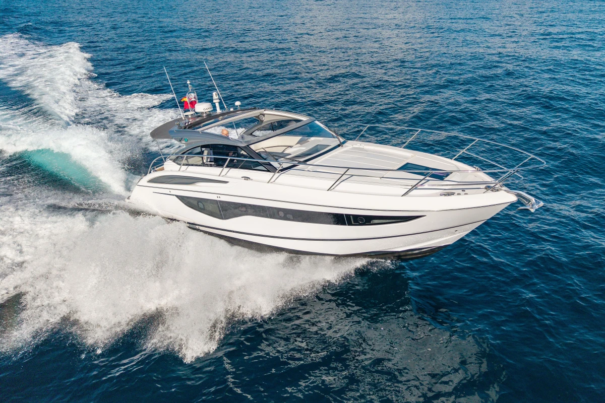 2019 Princess V40 yacht cruising on open sea, creating dynamic water splashes.