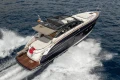 2017 Princess V48 Open yacht cruising on open water, rear view.
