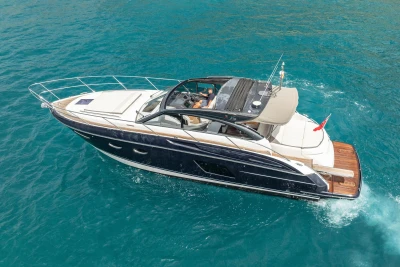 2017 Princess V48 Open yacht cruising on clear blue water.