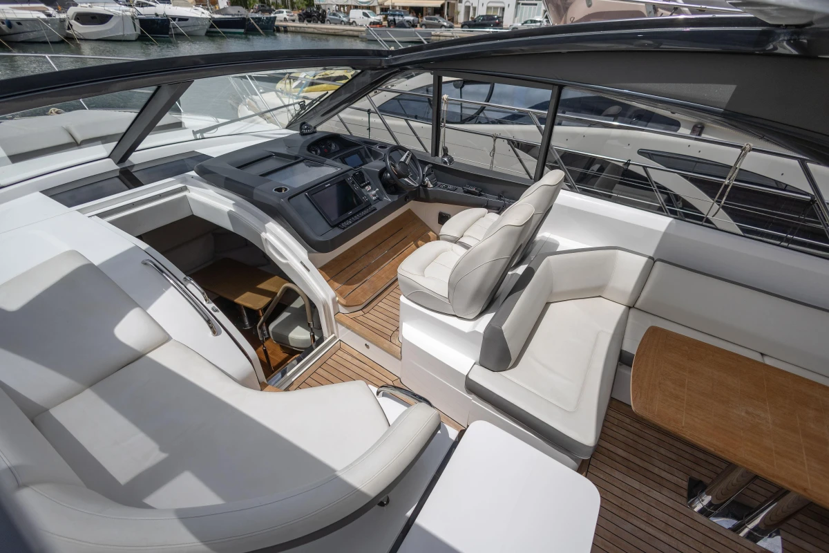 Luxurious 2017 Princess V48 Open yacht interior with sleek seating and modern dashboard.