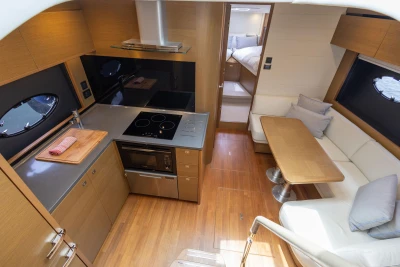 Luxurious interior of 2017 Princess V48 Open yacht with modern kitchen and cozy seating area.