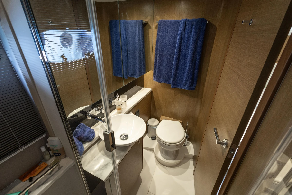 Luxurious bathroom in 2017 Princess V48 Open yacht with modern fixtures and wooden accents.