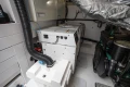 Engine room of 2017 Princess V48 Open yacht, featuring generator and mechanical components.