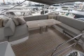 Luxurious 2023 Princess F55 yacht deck with elegant seating and wooden table.