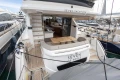 Luxury Princess F55 yacht, 2023 model, docked with elegant seating and dining area.