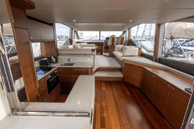 Luxurious interior of 2023 Princess F55 yacht with modern kitchen and seating area.