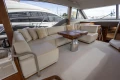 Luxurious interior of 2023 Princess F55 yacht with elegant seating and wooden table.