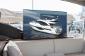 Luxurious 2023 Princess F55 yacht displayed on a screen in a stylish boat interior.