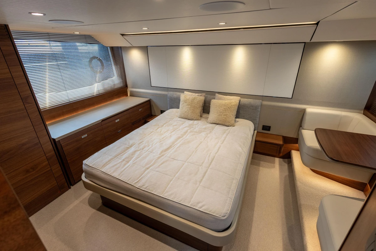 Luxurious bedroom interior of 2023 Princess F55 yacht with modern design and cozy furnishings.