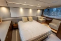 Luxurious bedroom interior of 2023 Princess F55 yacht with modern furnishings and ambient lighting.