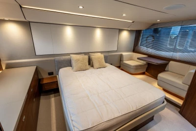 Luxurious bedroom interior of 2023 Princess F55 yacht with modern furnishings and ambient lighting.