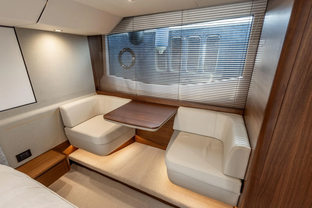 Luxurious interior of 2023 Princess F55 yacht with elegant seating and wooden accents.
