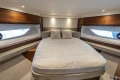 Luxurious bedroom interior of 2023 Princess F55 yacht with elegant wood accents.