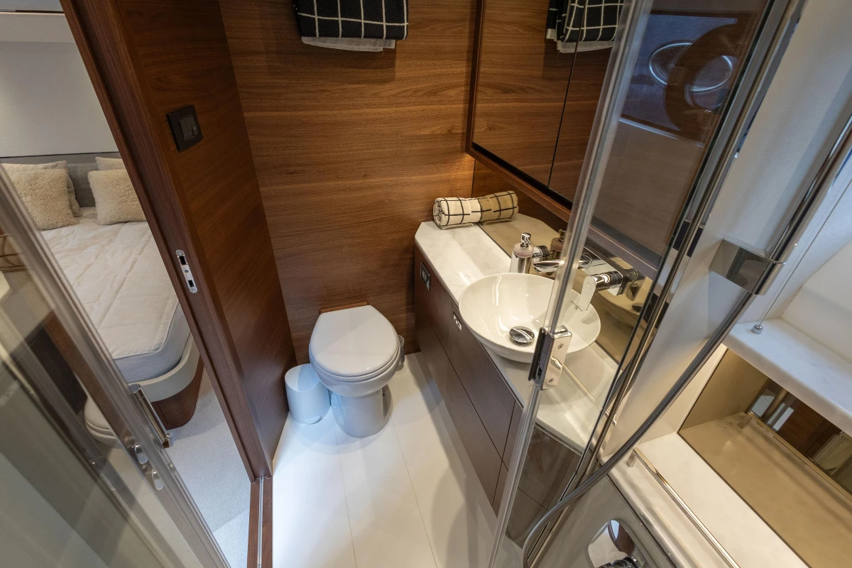 Luxurious bathroom in 2023 Princess F55 yacht with modern fixtures and wood accents.