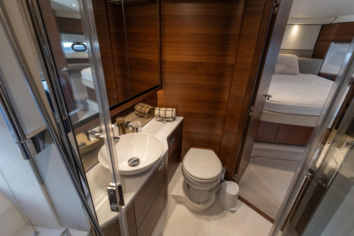 Luxurious bathroom on 2023 Princess F55 yacht with modern fixtures and wood accents.