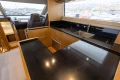 Luxurious kitchen interior of 2014 Princess 56 yacht with sleek black countertops.