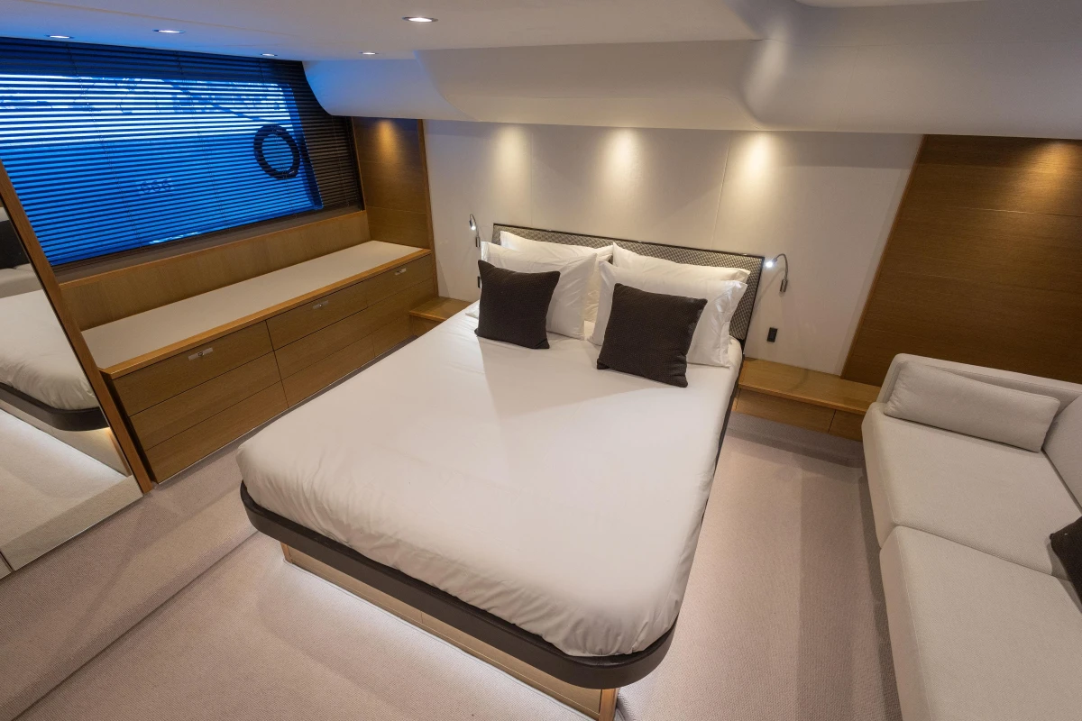 Luxurious bedroom interior of 2014 Princess 56 yacht with modern design and elegant furnishings.