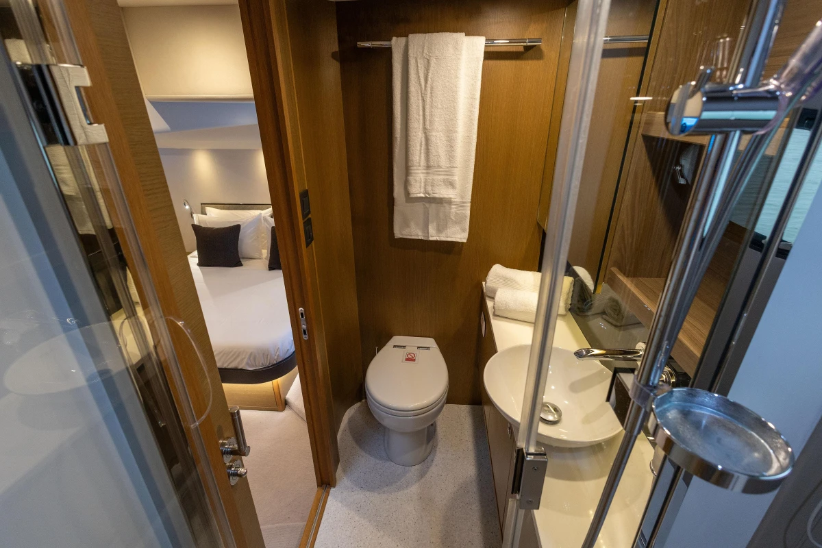 Luxurious bathroom and bedroom interior of 2014 Princess 56 yacht, featuring modern amenities.