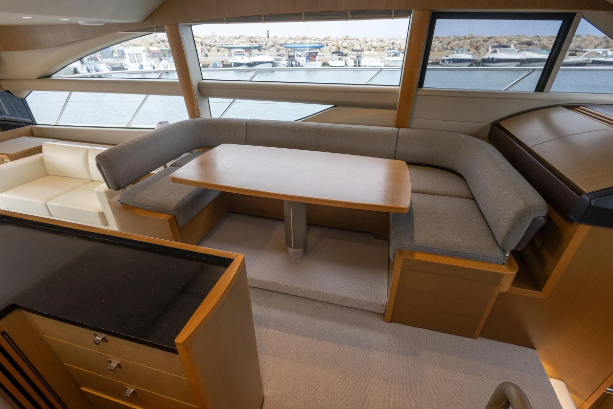 Luxurious interior of 2014 Princess 56 yacht with elegant seating and dining area.