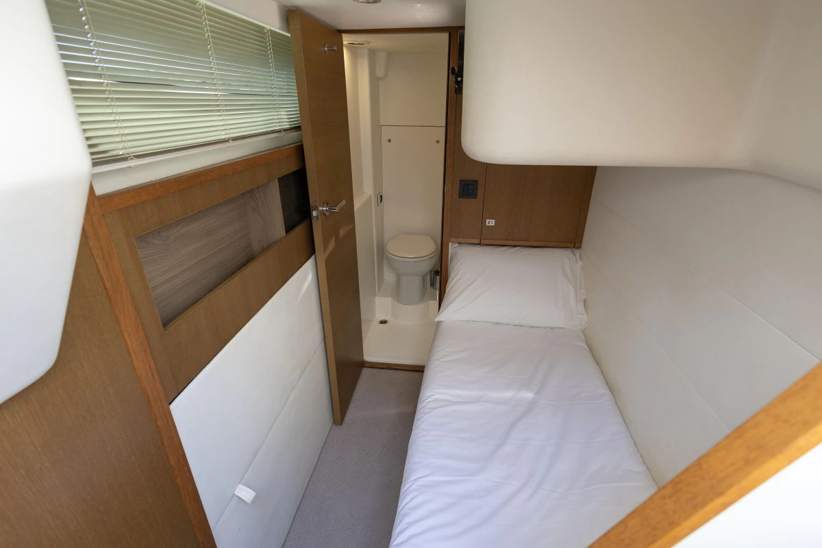 Compact cabin interior of 2014 Princess 56 yacht with bed and bathroom.
