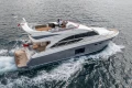 Luxurious 2014 Princess 56 yacht cruising on open water, showcasing sleek design and elegance.