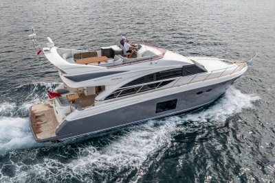 Luxurious 2014 Princess 56 yacht cruising on open water, showcasing sleek design and elegance.