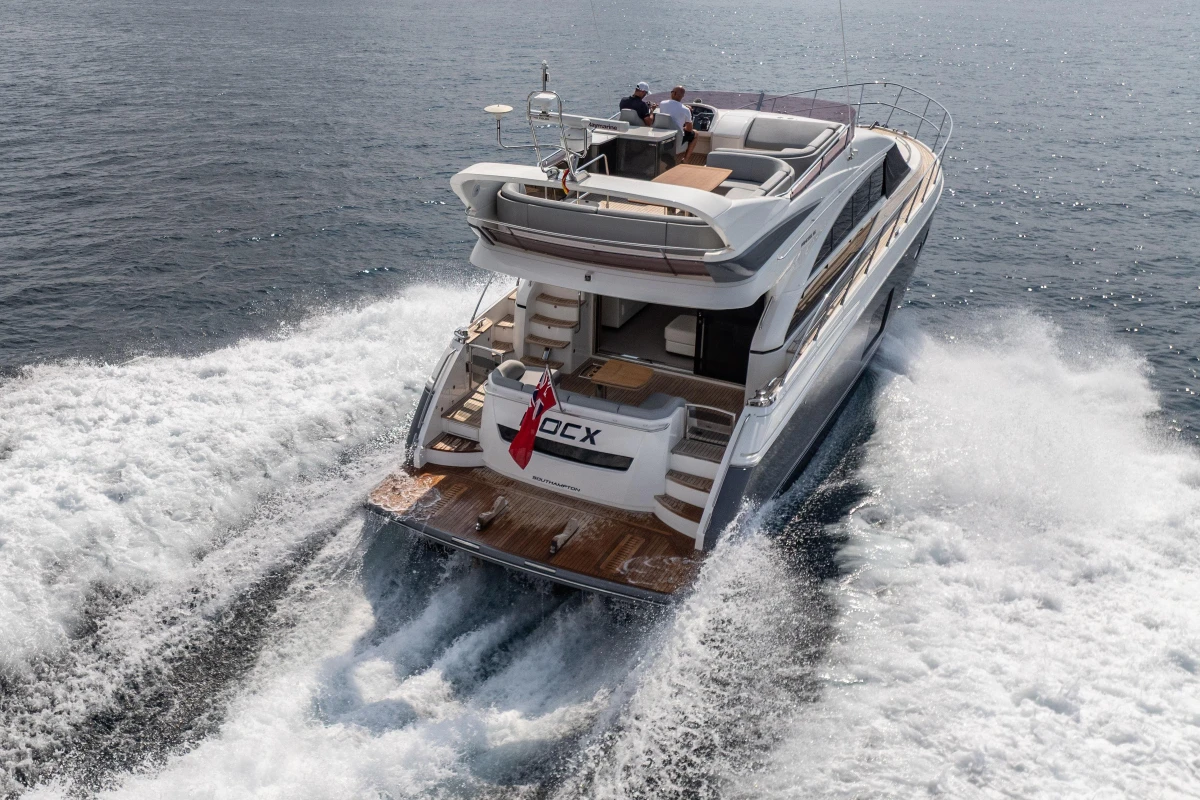 Luxury 2014 Princess 56 yacht cruising on open water, rear view.