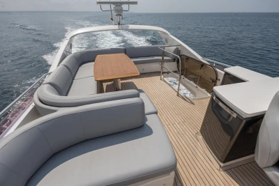 Luxurious 2014 Princess 56 yacht with spacious deck and elegant seating on open sea.