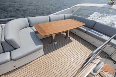 Luxurious 2014 Princess 56 yacht deck with elegant seating and wooden table.