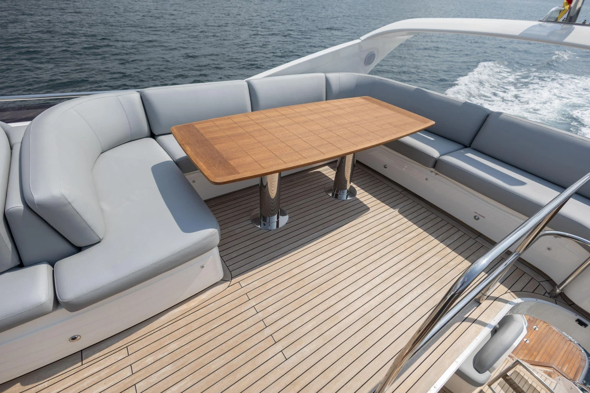 Luxurious 2014 Princess 56 yacht deck with elegant seating and wooden table.