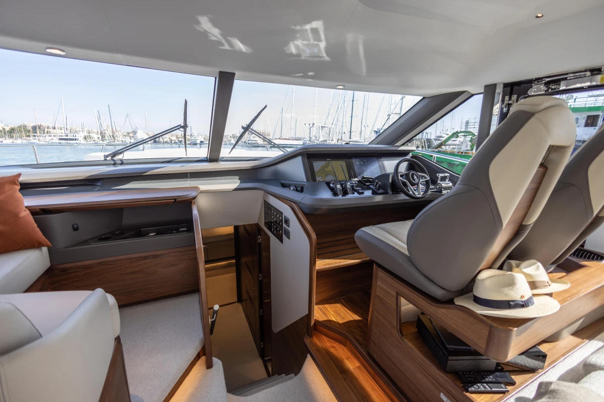 Luxurious interior of 2026 Princess Y72 yacht, featuring modern helm and seating.