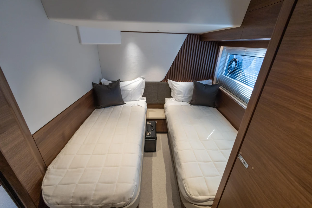 Luxurious twin cabin in 2026 Princess Y72 yacht, featuring modern design and cozy bedding.
