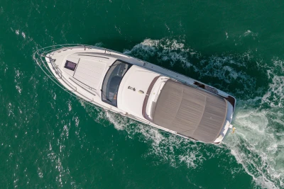 Aerial view of 2023 Princess F50 yacht cruising on turquoise water.