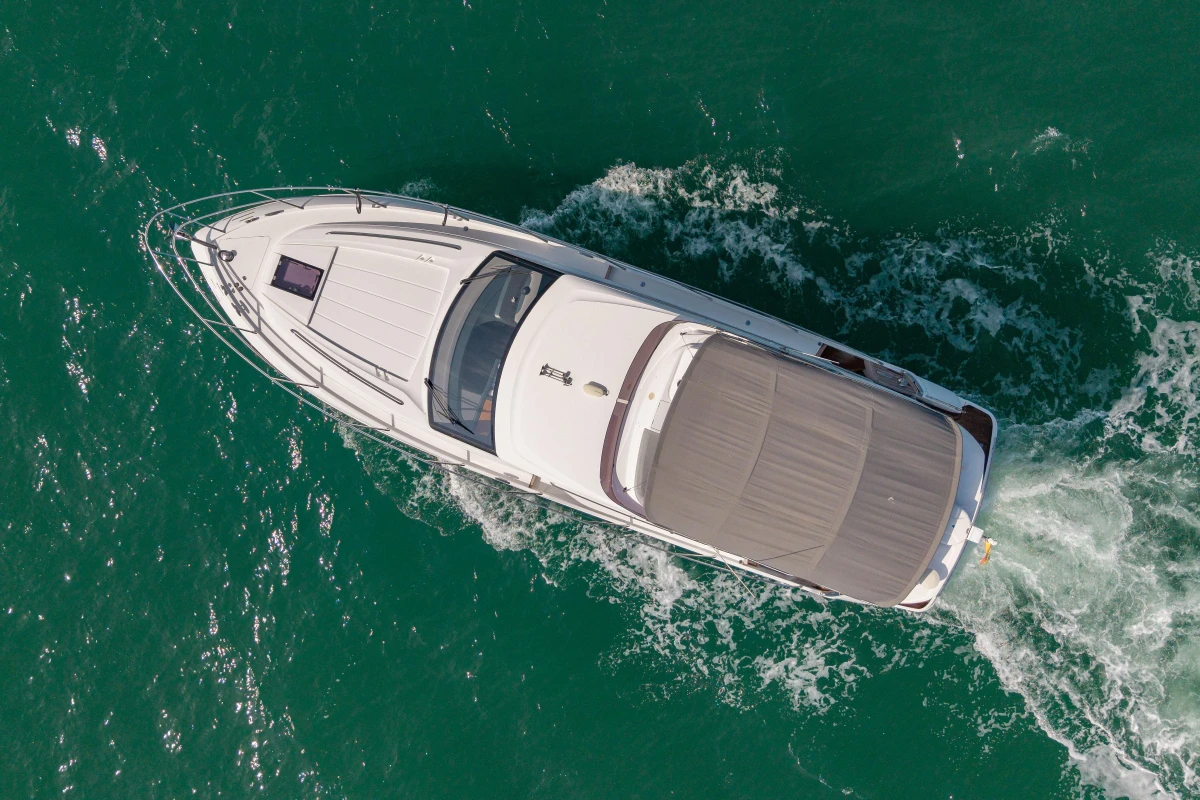 Aerial view of 2023 Princess F50 yacht cruising on turquoise water.