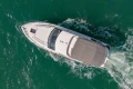 Aerial view of 2023 Princess F50 yacht cruising on turquoise water.