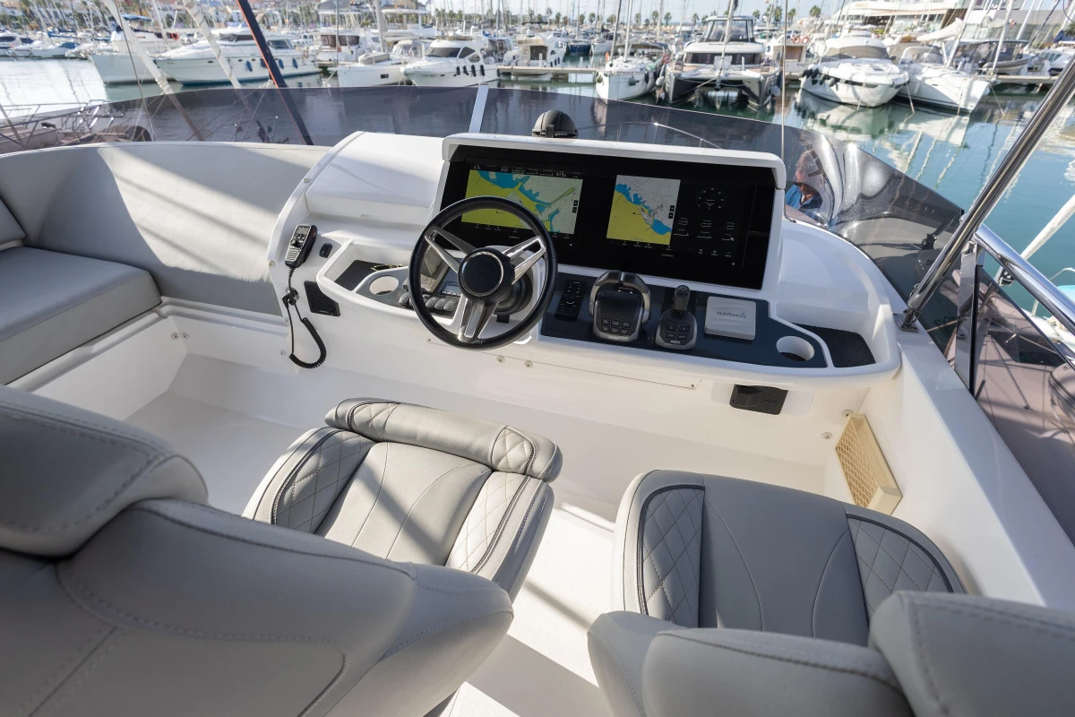 Luxury yacht helm with modern navigation system, Princess F50, 2023 model, docked at marina.