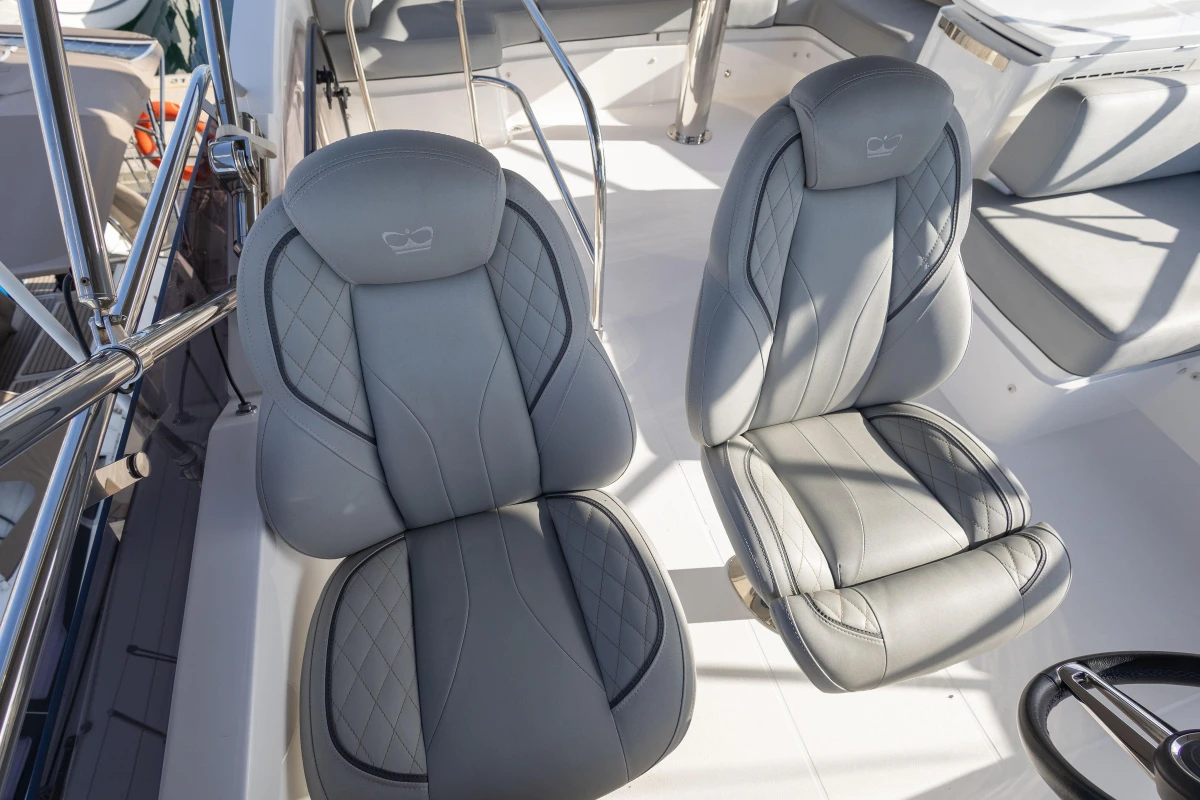 Luxury seating on 2023 Princess F50 yacht, featuring elegant gray upholstery and modern design.