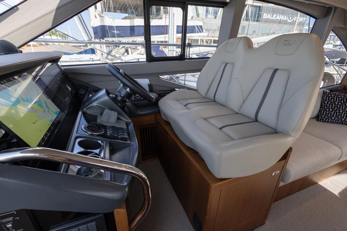 Luxurious interior of 2023 Princess F50 yacht with modern helm and plush seating.