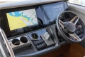 Control panel of 2023 Princess F50 yacht with navigation screens and steering wheel.