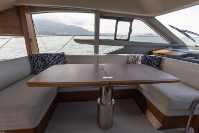 Luxurious interior of 2023 Princess F50 yacht with elegant seating and table.
