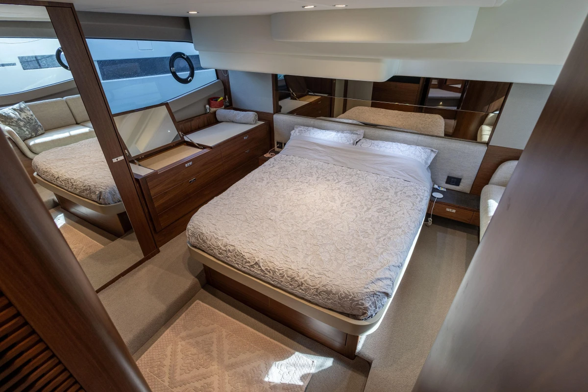 Luxurious bedroom interior of 2023 Princess F50 yacht with elegant wood finishes and modern design.