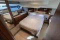 Luxurious bedroom interior of 2023 Princess F50 yacht with elegant wood finishes and modern design.