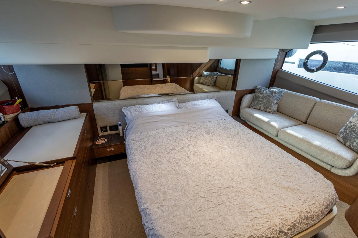 Luxurious 2023 Princess F50 yacht bedroom with elegant decor and comfortable seating.