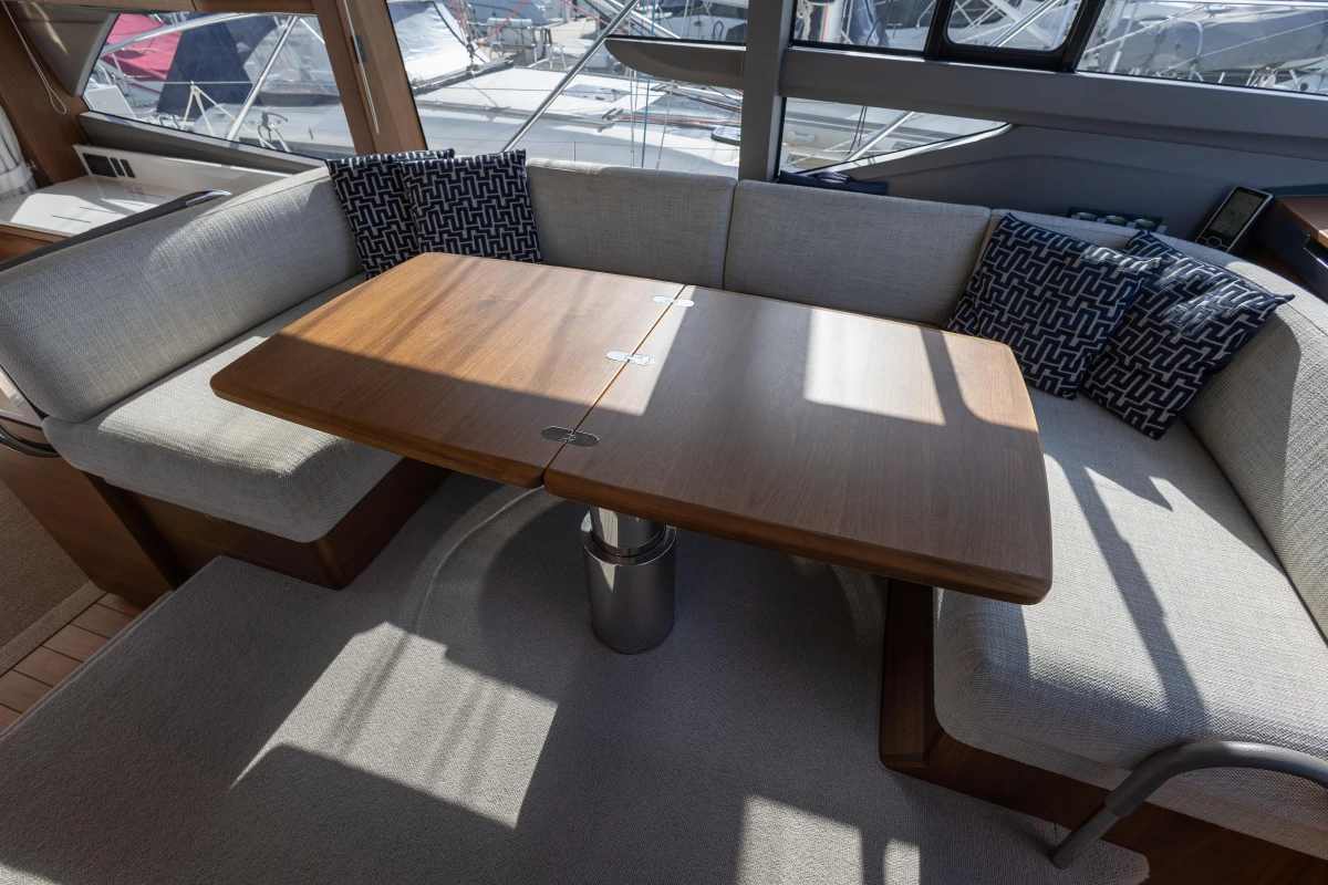 Luxurious interior of 2023 Princess F50 yacht with elegant seating and wooden table.